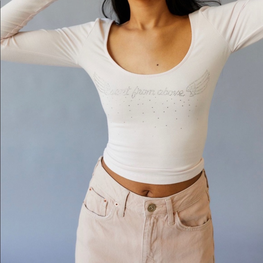 Urban Outfitters long-sleeve pink top with rhinestone detailing.